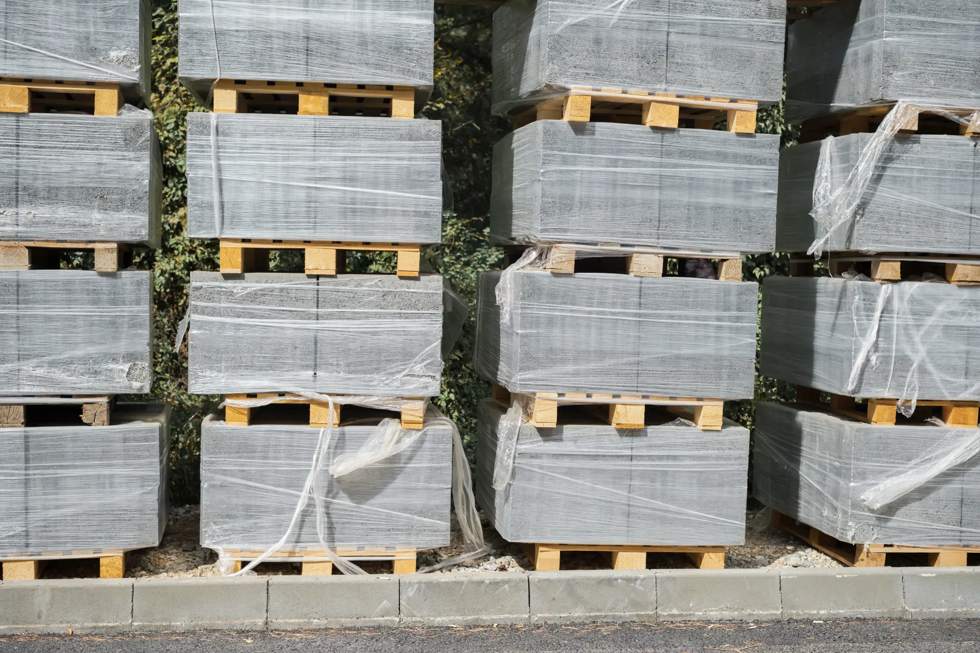Pallets of stacked slabs wrapped in plastic film